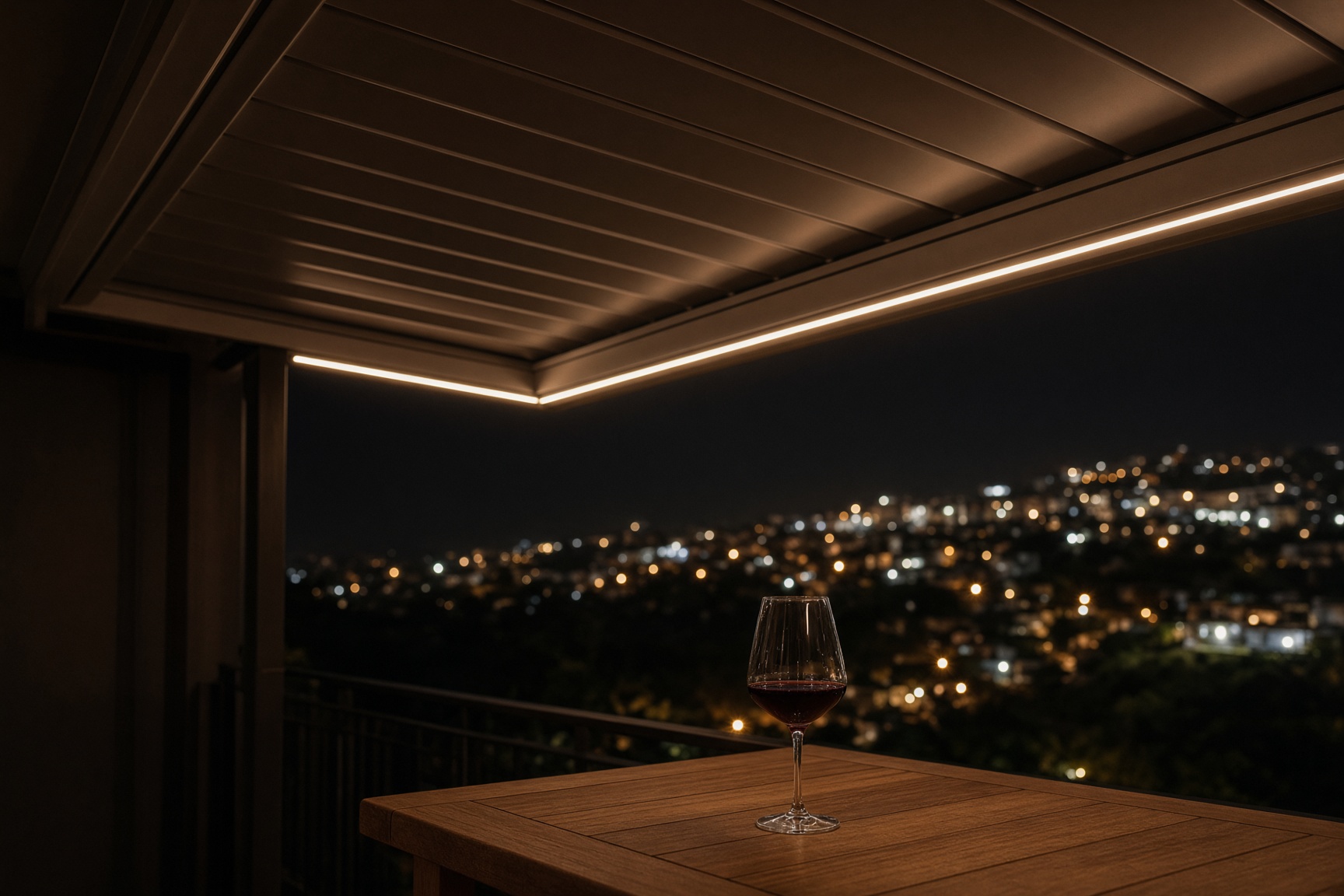 Warm recessed light along the underside of a louvered roof at night